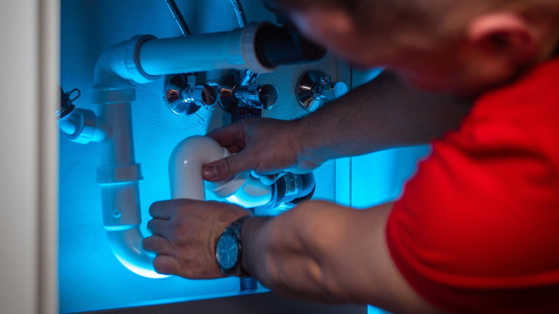 Licensed plumber working on residential pipe system in Bakersfield