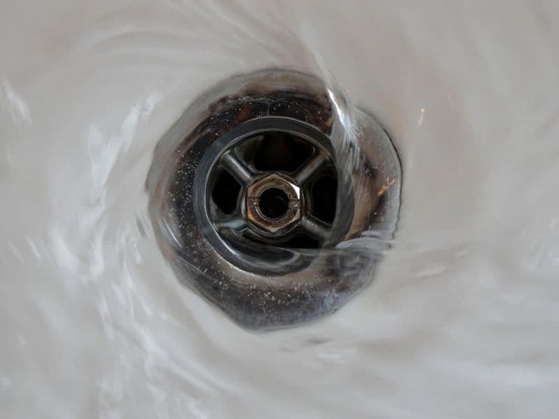Plumber performing professional drain cleaning service