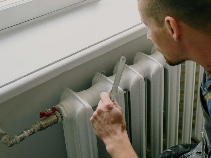 Technician using thermal imaging for non-invasive leak detection