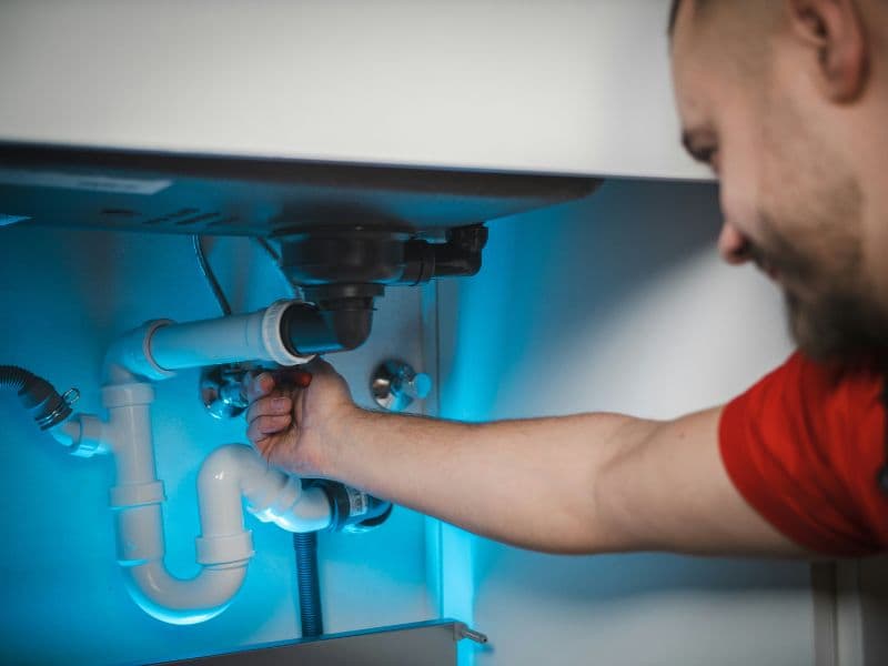 Plumber installing new PEX piping during a whole-home repipe